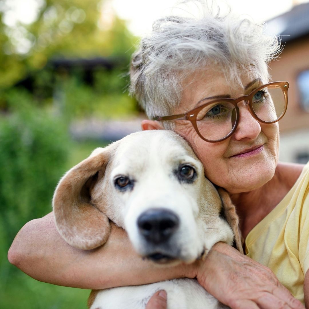Old woman hugging a dog